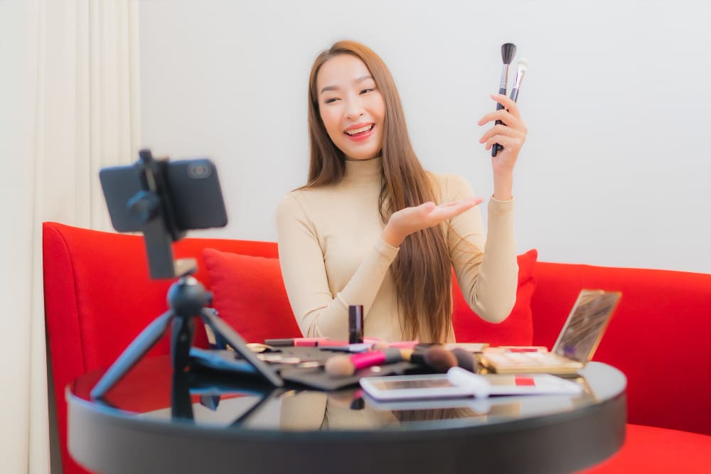 Portrait of beautiful young asian micro-influencer woman review cosmetics products