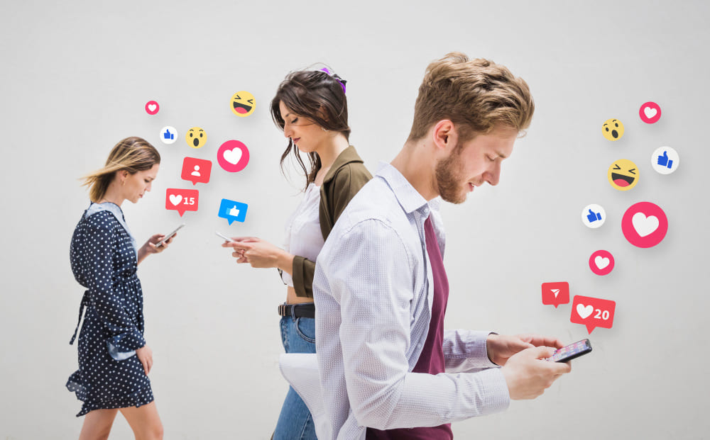 Social media users walking while looking at their phones, surrounded by floating reaction emojis.